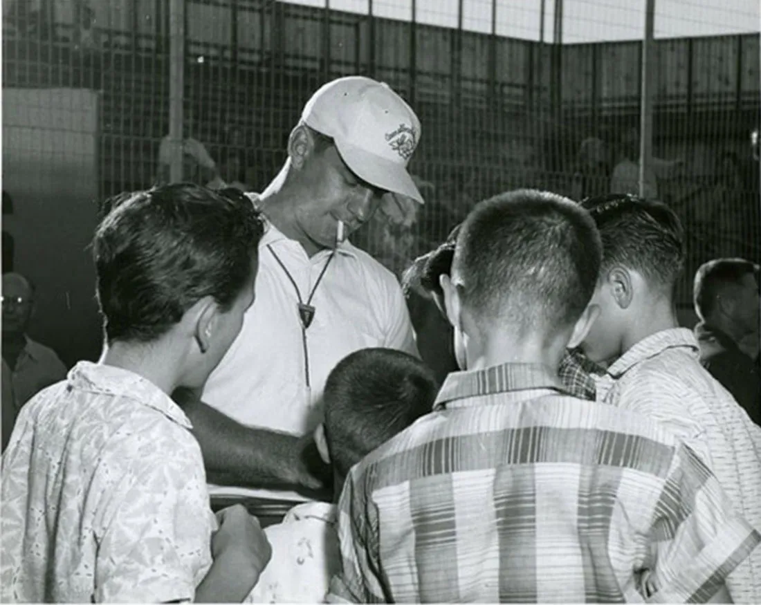A group of children surrounding a coach