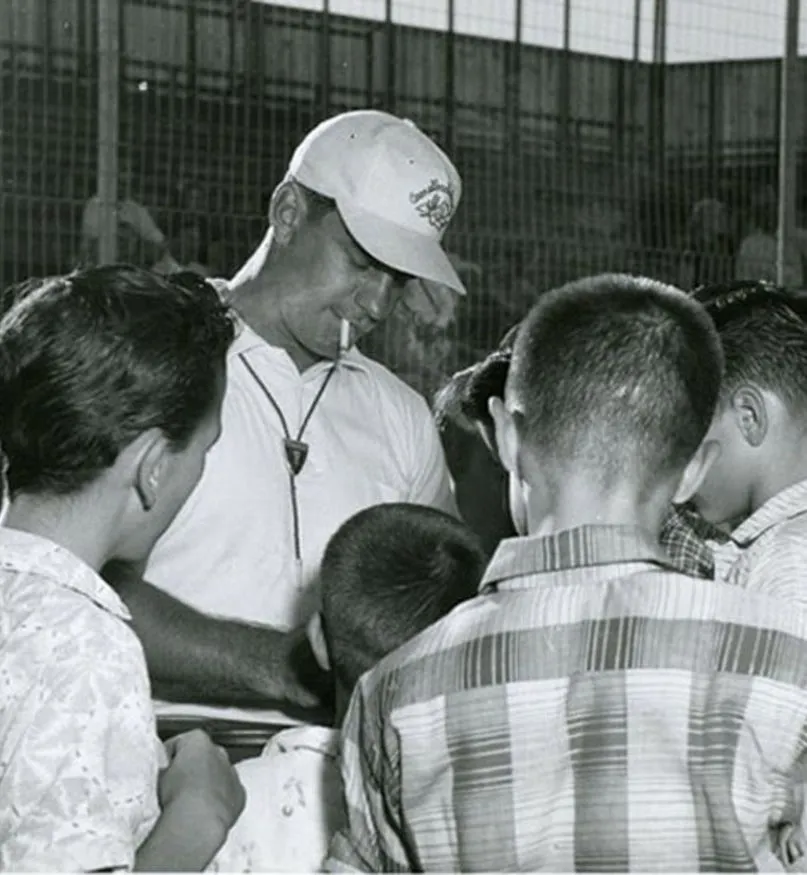A group of children surrounding a coach