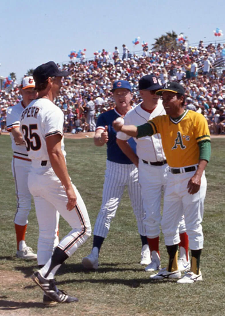 A group of baseball players meeting on the field during a sunny day.